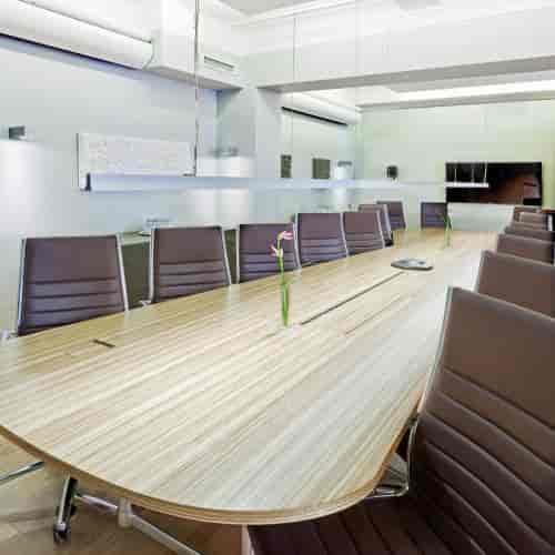 Modern conference room at Klaus K Hotel with a sleek wooden table and tech-ready design.