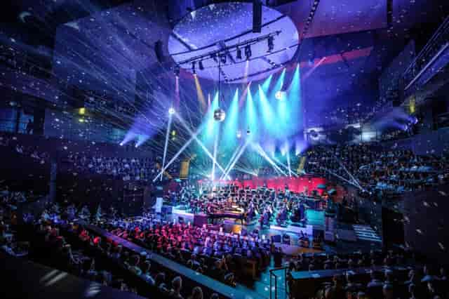 Glazed Foyer at Musiikkitalo events with dynamic lighting and engaged audience.
