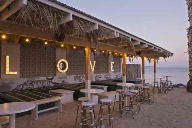 Café & Beach venue with illuminated "LOVE" sign, perfect for romantic events and gatherings.