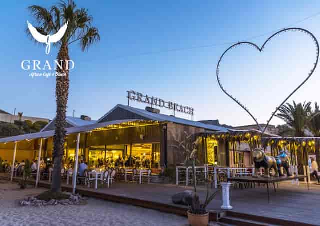 Outdoor event venue with stylish seating at Grand Africa Café & Beach, ideal for weddings.