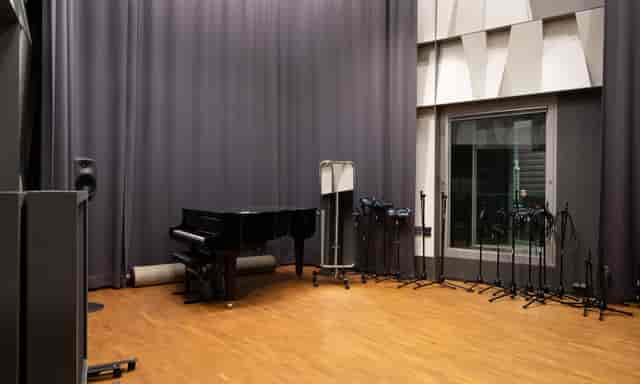 Large recording room in Uniarts Helsinki with grand piano, ideal for music events.