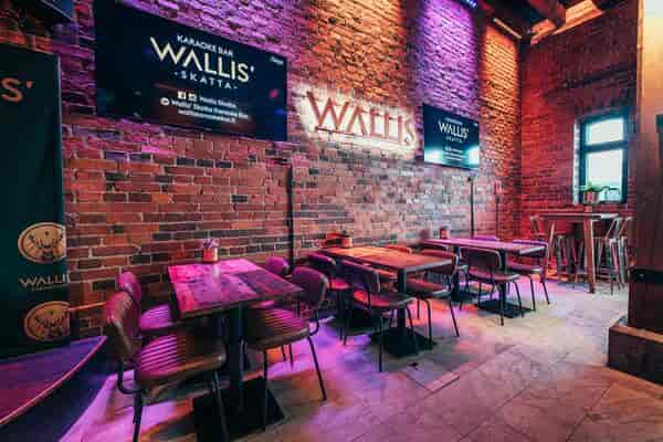 Vibrant event space at Ravintola Nokka with exposed brick, ideal for gatherings and meetings.