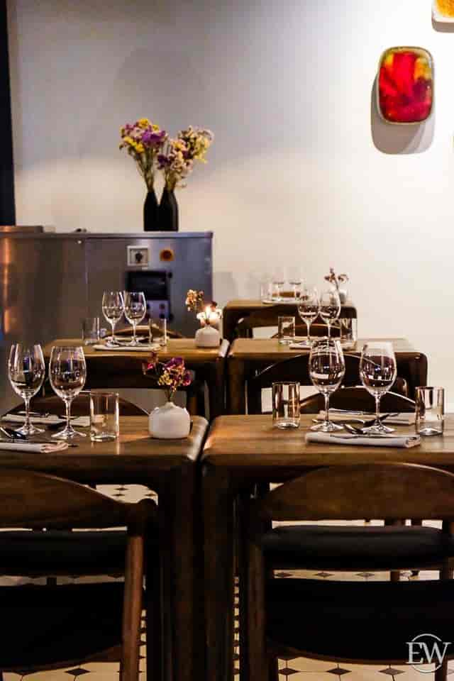 Upscale dining setup with floral centerpieces at Restaurant Nolla for intimate events.