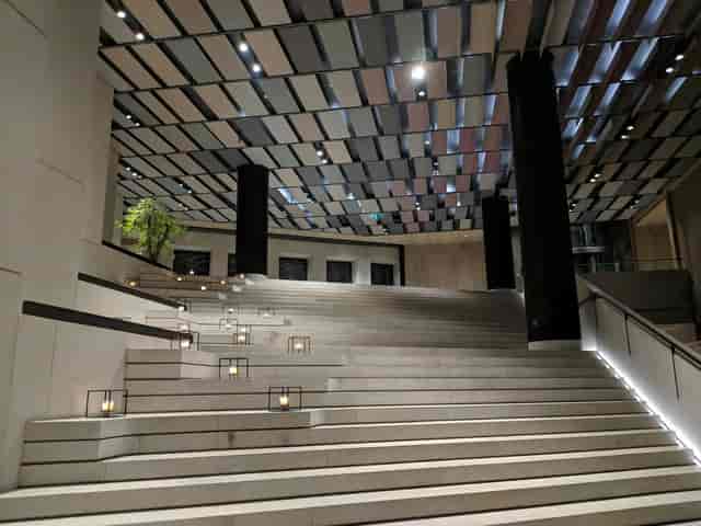 Sleek modern venue with dramatic staircase, ideal for corporate events and receptions.