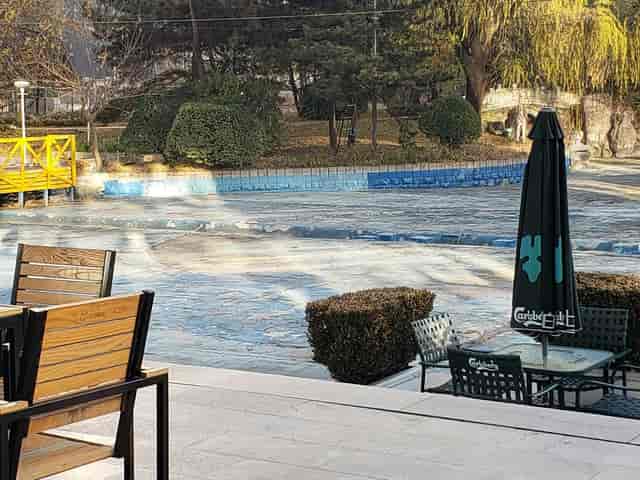 Outdoor venue at The Great Wall Hotel, featuring a pool and event seating.