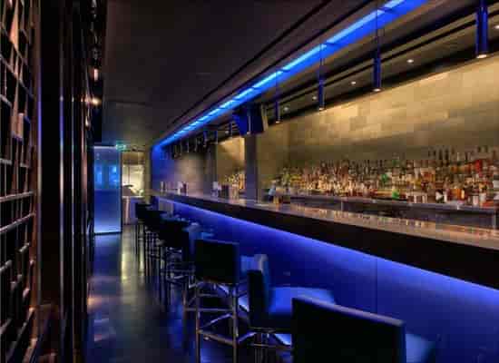 Sleek Hakkasan lounge bar with ambient lighting for cocktail receptions and networking events.