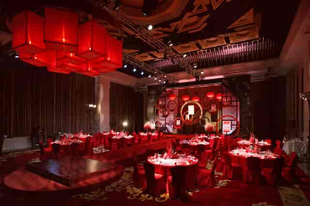 Grand Ballroom at Yanqi Hotel Beijing, elegant red decor for banquets and corporate events.