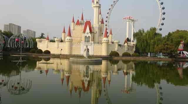 "Whimsical castle by pond at Shijingshan Amusement Park, perfect for events and weddings."
