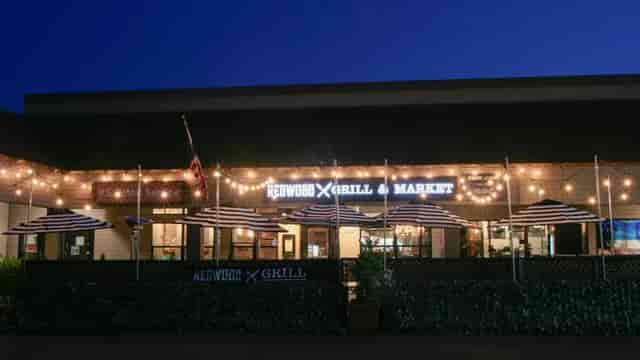 Private Barrel Room patio at Redwood Grill with string lights, perfect for casual events.
