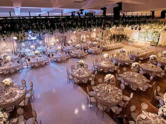 Elegant wedding banquet setup at Eternity, featuring lush floral centerpieces and soft lighting.