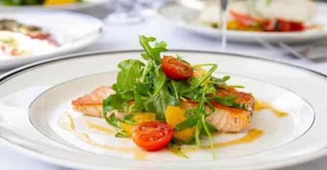 "Elegant salmon dish with arugula, perfect for corporate gala or upscale banquet."