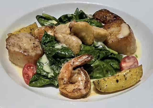 Elegant seafood dish with scallops and shrimp, ideal for Mistral restaurant events.
