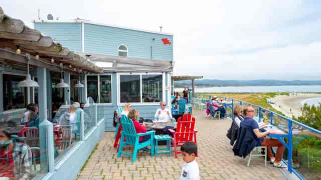 Outdoor dining area at Sam's Chowder House for casual events, with vibrant chairs and coastal views.