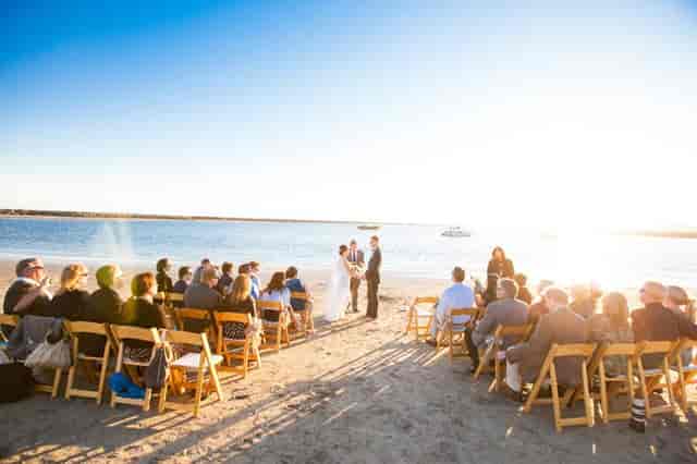 Beachfront wedding setup at Sam's Chowder House with sunset backdrop. Ideal outdoor ceremony.