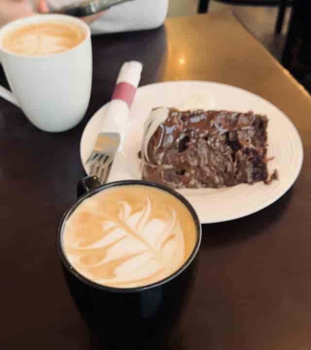 Espresso bar latte art and chocolate cake at Caffe Cittadella for events and networking.