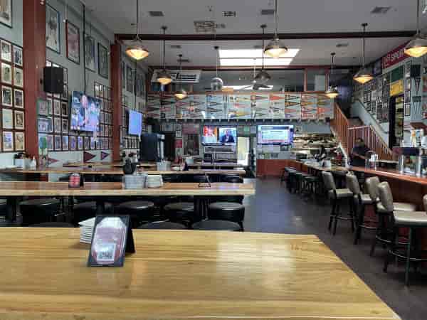 Spacious BarZola restaurant with sports decor, ideal for casual gatherings and events