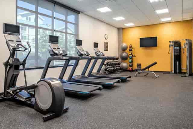 Modern fitness room in Homewood Suites for wellness events and team-building activities.