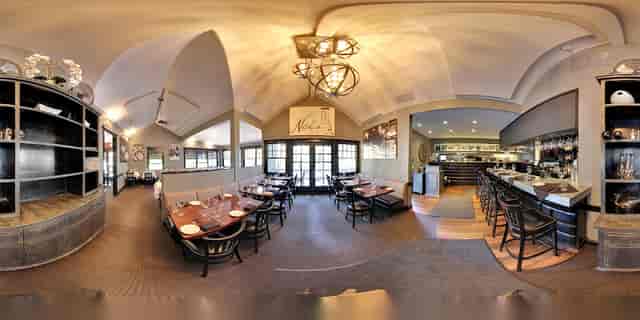 Stylish restaurant interior with warm lighting, perfect for corporate events and gatherings.