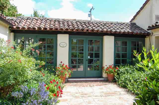 Charming Sunset Room venue for intimate events with lush landscaping, ideal for workshops.