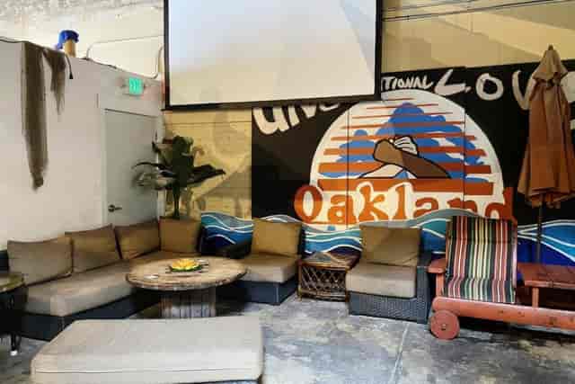 Cozy patio meeting space with comfortable seating and local artwork for creative gatherings.