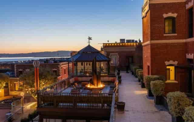 Rooftop venue at Fairmont Ghirardelli Square, cozy fire pit, ideal for evening events.