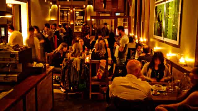 Vibrant Flour + Water restaurant with warm candlelight, ideal for gatherings and events.