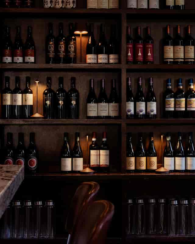 Elegant wine display at 54 Mint Cucina Romana for upscale events and networking.