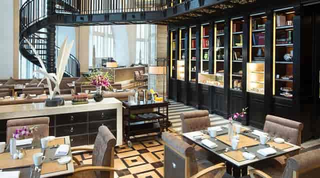 Elegant dining space with spiral staircase for corporate events in Conrad Beijing.