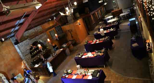 Spacious La Honda Winery tasting room with purple tables, ideal for events and gatherings.