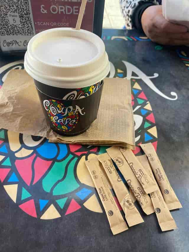 Coffee setup at Coupa Cafe with branded cup, ideal for networking events and meetings.