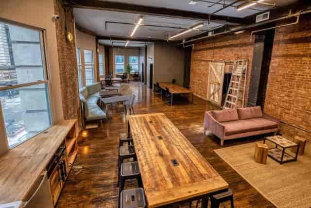 Open Space Coworking, versatile event space with exposed brick walls for workshops and networking.