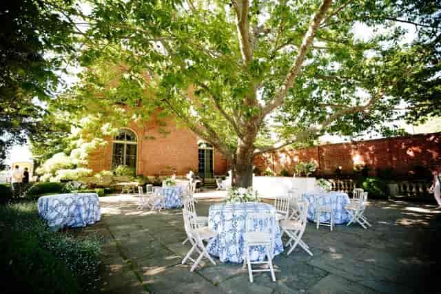 Elegant outdoor event space at Filoli with floral tablecloths, perfect for weddings and gatherings.