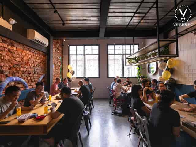 Vibrant dining space with communal tables for networking events and team-building activities.