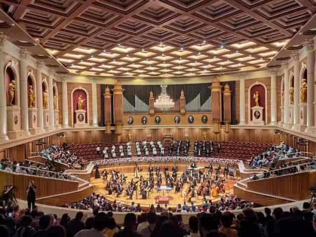 "Orchestra performing in elegant Aula Simfonia Jakarta concert hall for corporate events"