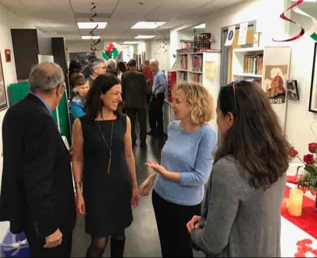 Vibrant networking event at Italian Cultural Society with festive decor and diverse attendees.