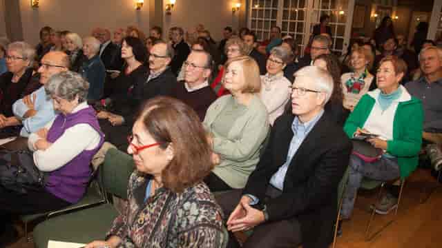 Engaged audience at a well-lit Italian Cultural Society networking event.
