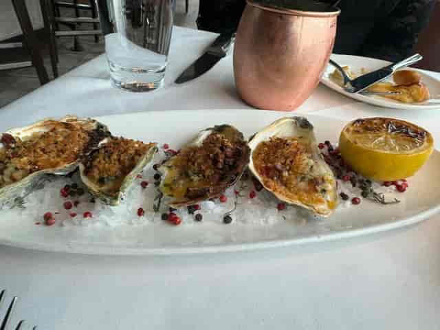 Baked oysters on ice at Del Frisco's Double Eagle Steak House for elegant events.