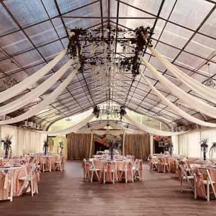 Elegant corporate event venue with draped ceiling, perfect for weddings and gatherings.