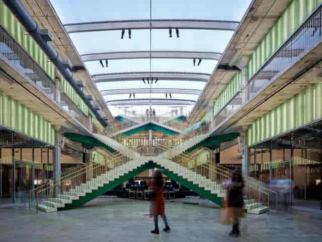 Modern event space in X Atrium with double staircase for corporate meetings and gatherings.