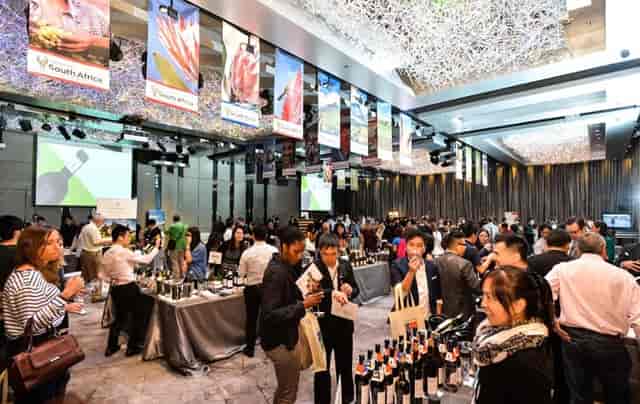 Silverbox Ballroom at Hotel ICON during a lively wine tasting event with attendees mingling.