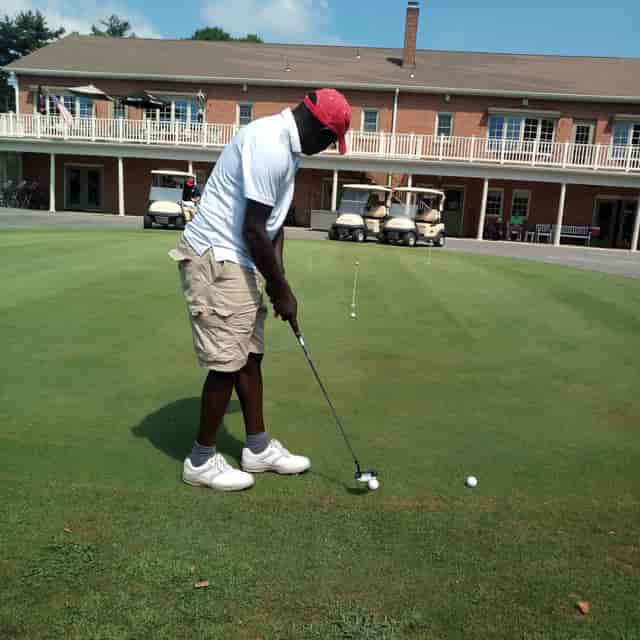 Golfer putting on green at Westwood Golf Club, perfect for corporate retreats and networking.