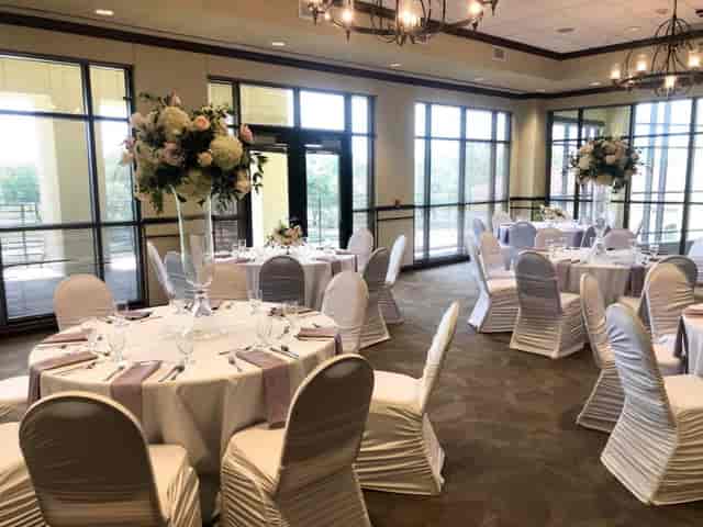 Elegant Magnolia Ballroom with round tables, perfect for weddings and corporate events.