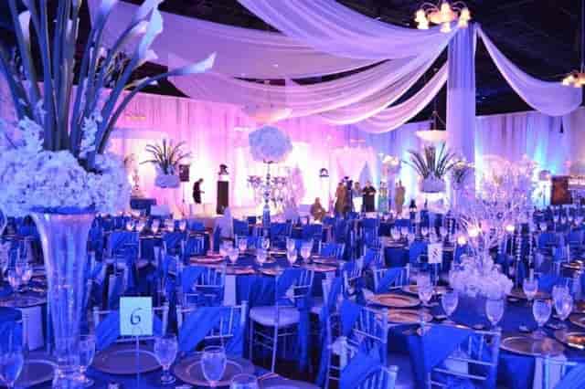 Elegant event space at The Grande Ballroom, Houston, with tall floral arrangements.