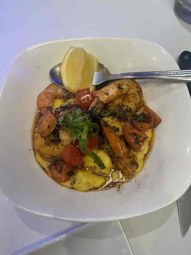 Plated shrimp dish with grits in The Oceanaire Seafood Room - catering, event aesthetics.