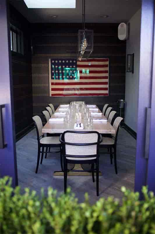 Private dining room with minimalist table, ideal for intimate meetings and gatherings.