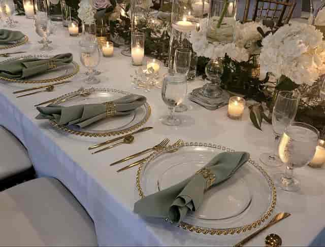 Elegant wedding table setting with charger plates and candles at Venetian Terrace venue.