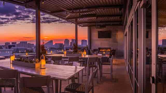 Stylish rooftop lounge with sunset view, perfect for corporate events and gatherings.