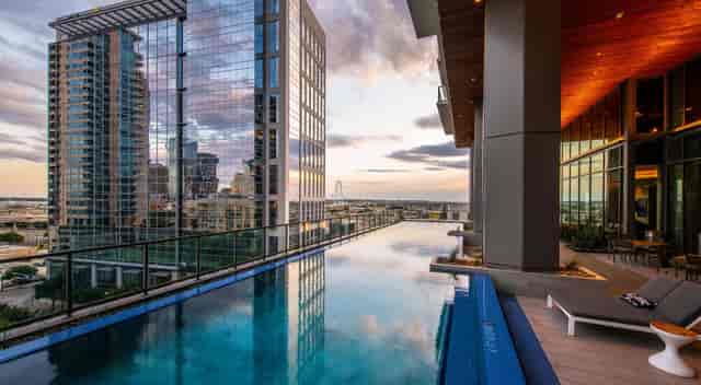 Stunning W Dallas rooftop venue with infinity pool and city skyline at sunset.