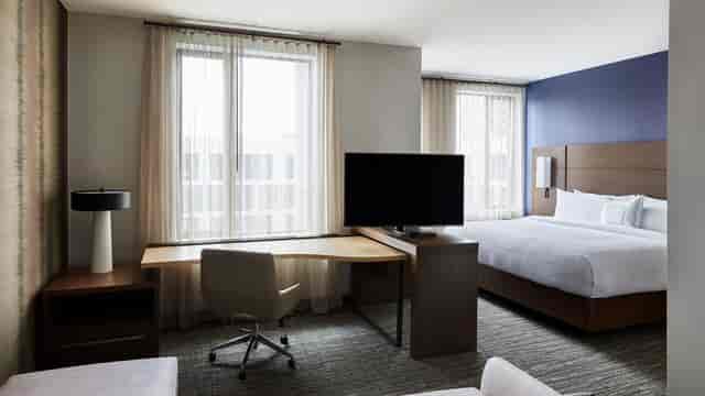 Contemporary hotel room at Residence Inn Dallas, ideal for business travelers and meetings.