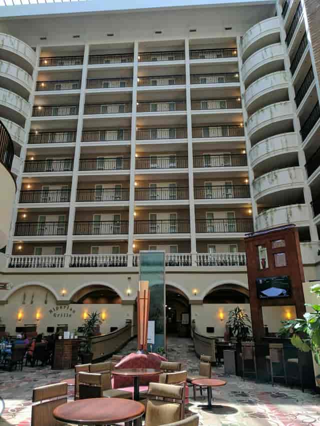 Atrium at Embassy Suites Dallas, featuring balconies, ideal for networking events.
